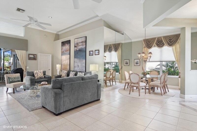 tiled living room with a towering ceiling, ceiling fan with notable chandelier, and crown molding