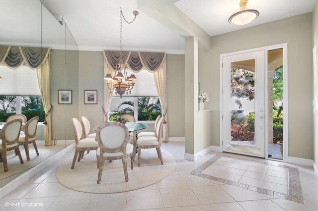 dining space featuring light tile patterned floors and an inviting chandelier