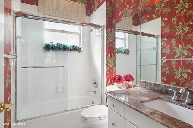 full bathroom with wallpapered walls, toilet, vanity, and enclosed tub / shower combo