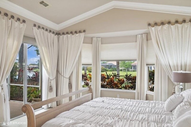 bedroom with multiple windows, crown molding, and vaulted ceiling