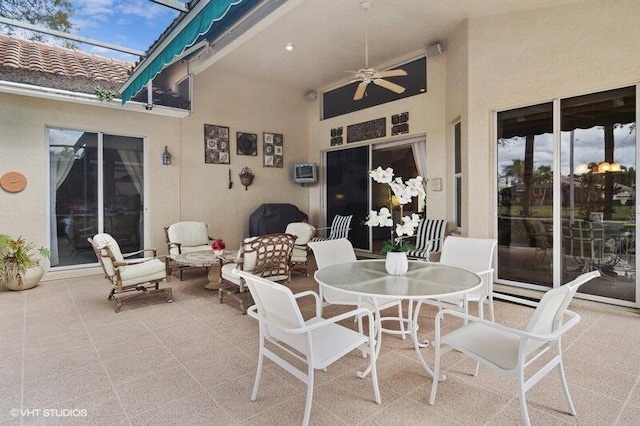 view of patio / terrace with outdoor dining space and a ceiling fan