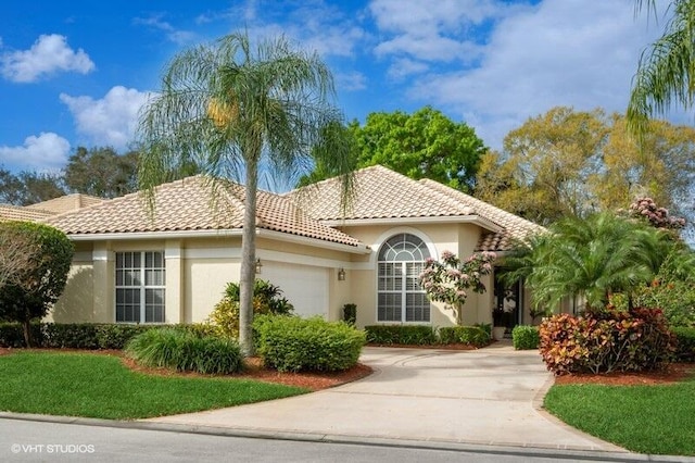 mediterranean / spanish house featuring a garage