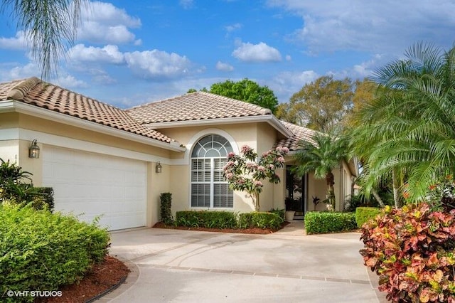 mediterranean / spanish home with a garage