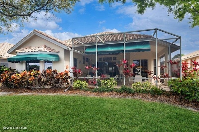 back of house with a yard and a lanai