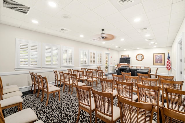 dining space with baseboards, visible vents, and ceiling fan