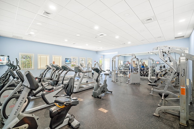 gym with a paneled ceiling