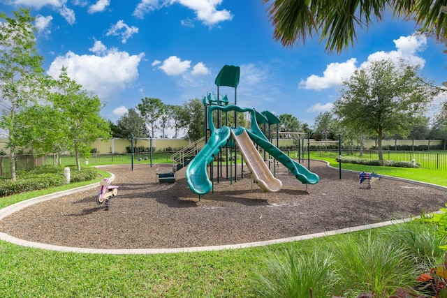 view of jungle gym featuring a lawn