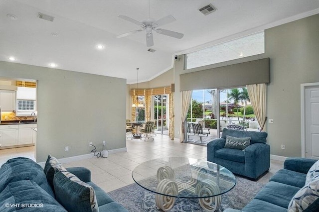 living room featuring visible vents, ceiling fan, baseboards, lofted ceiling, and light tile patterned floors