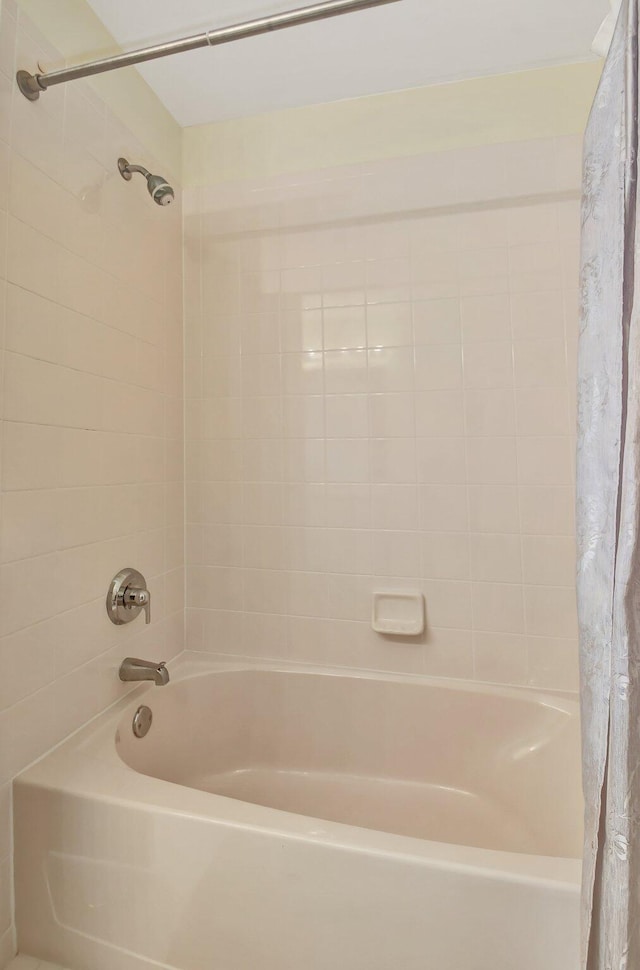 bathroom with shower / tub combo with curtain