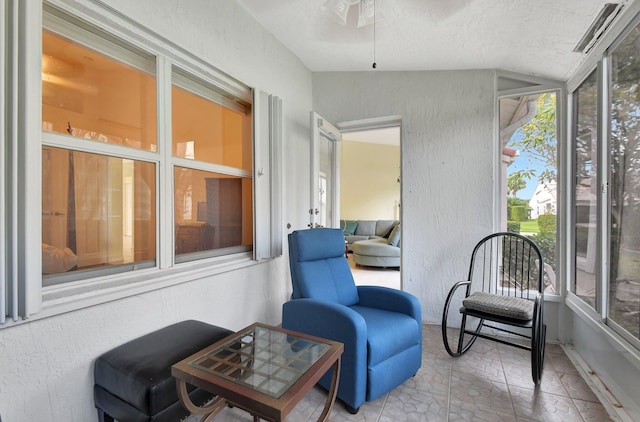 sunroom with ceiling fan and vaulted ceiling