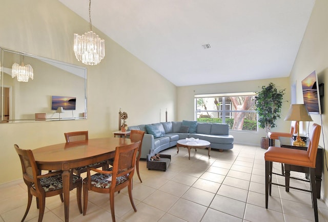 tiled dining area featuring vaulted ceiling