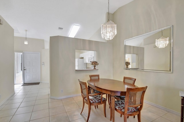 tiled dining space featuring high vaulted ceiling