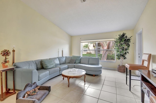 tiled living room with a textured ceiling and vaulted ceiling