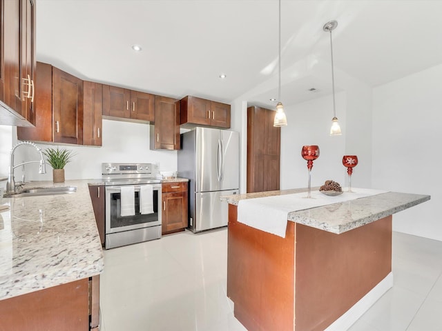 kitchen with light stone countertops, appliances with stainless steel finishes, sink, decorative light fixtures, and a center island