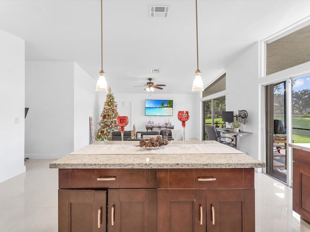 kitchen with ceiling fan, light tile patterned floors, and pendant lighting