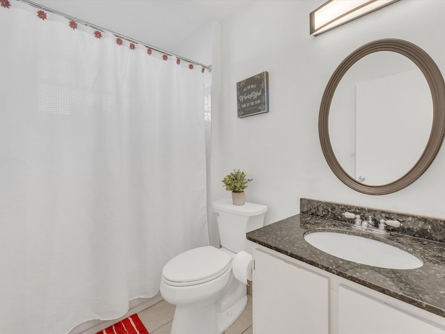 bathroom featuring toilet, vanity, and tile patterned floors