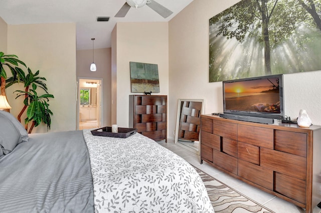 bedroom featuring light tile patterned floors, vaulted ceiling, ensuite bath, and ceiling fan