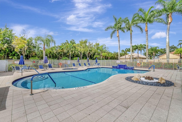 view of swimming pool with a community hot tub and a patio area