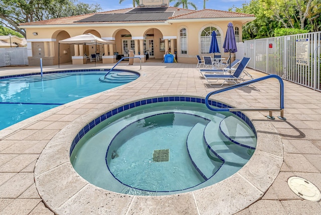 view of pool featuring a community hot tub, a patio, and french doors