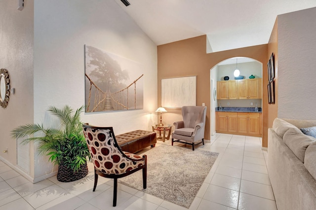 sitting room featuring light tile patterned floors and lofted ceiling