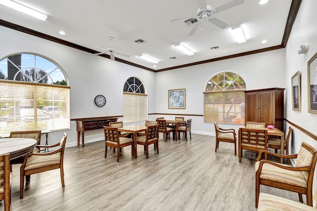 dining area with light hardwood / wood-style floors, ceiling fan, and ornamental molding