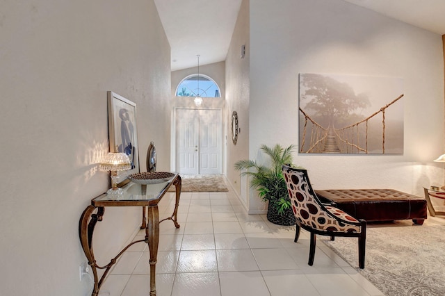 foyer featuring high vaulted ceiling and light tile patterned flooring