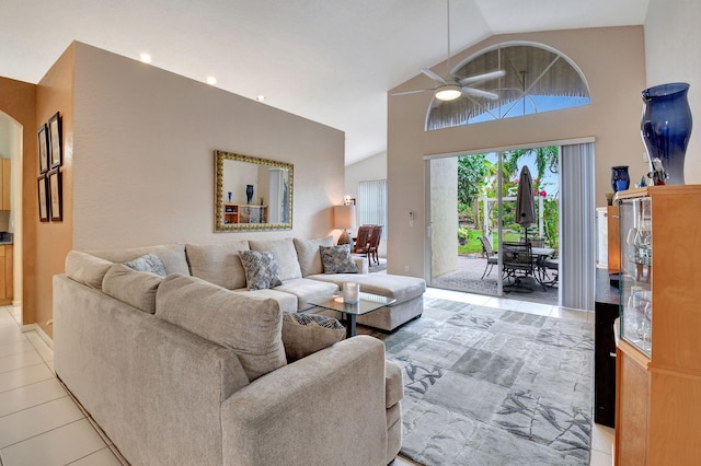 living room with ceiling fan, light tile patterned floors, and high vaulted ceiling