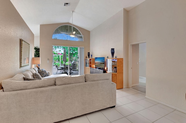 tiled living room featuring high vaulted ceiling