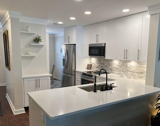 kitchen with kitchen peninsula, white cabinetry, and stainless steel appliances