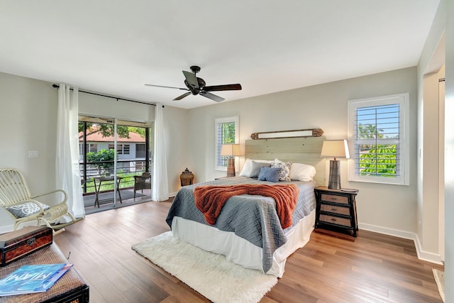 5770 Princess Palm Ct Unit F, Delray Beach, FL 33484 - bedroom featuring access to outside, multiple windows, and wood finished floors