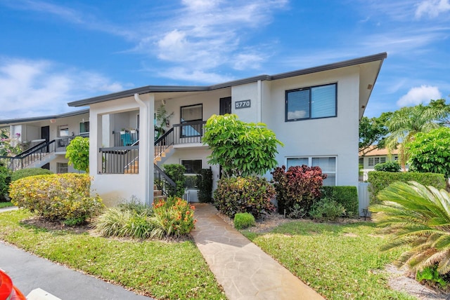 5770 Princess Palm Ct Unit F, Delray Beach, FL 33484 - townhome / multi-family property with stairs and stucco siding