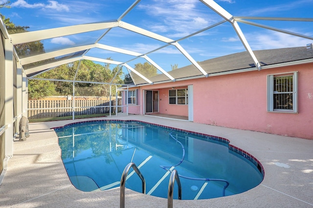 view of pool with a patio and a lanai