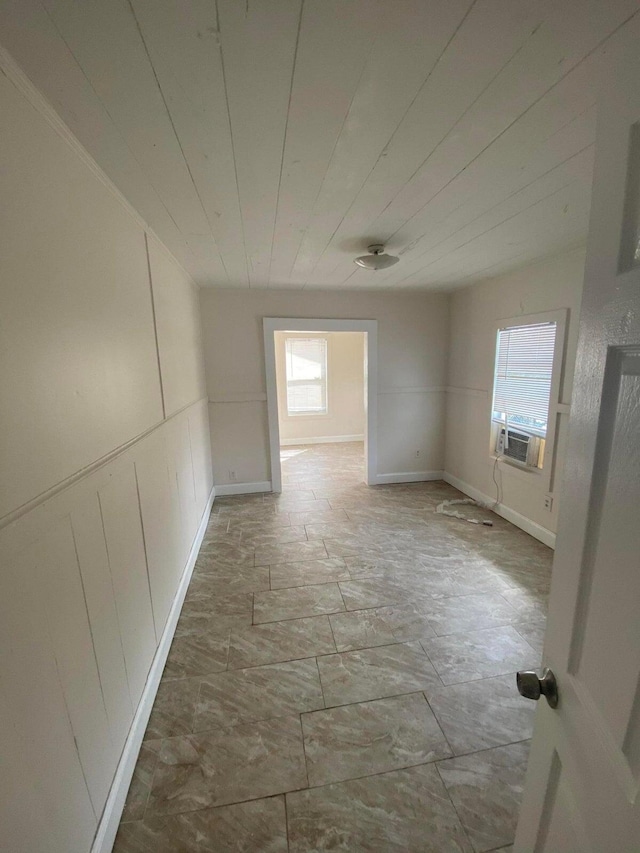 unfurnished room with cooling unit and wooden ceiling