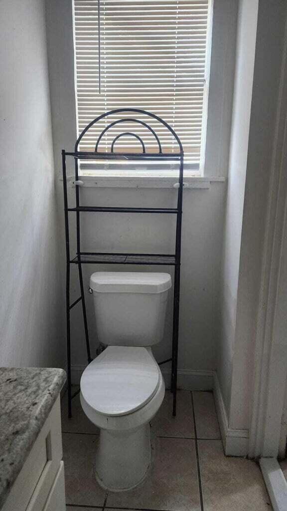 bathroom with toilet and tile patterned flooring