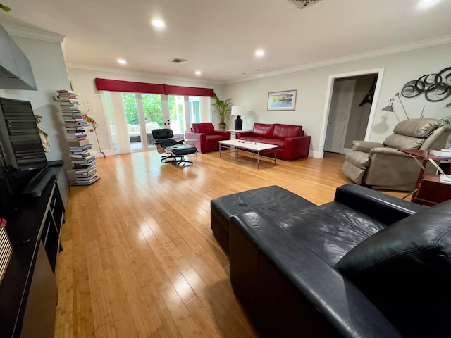 living room featuring light hardwood / wood-style flooring and crown molding