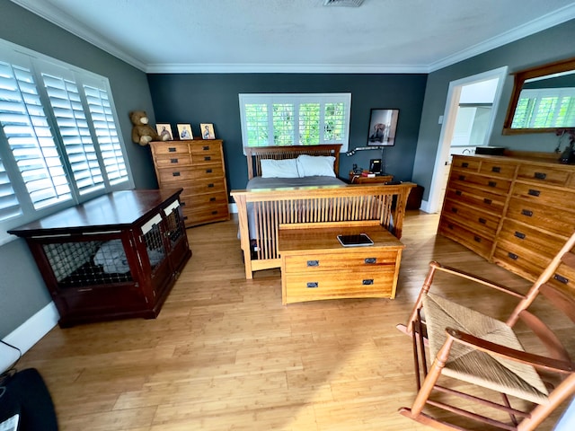 bedroom featuring light hardwood / wood-style floors and crown molding