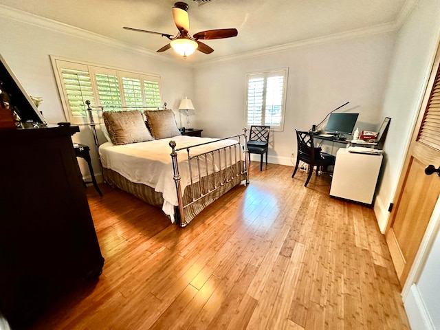 bedroom with light hardwood / wood-style floors, ceiling fan, and crown molding