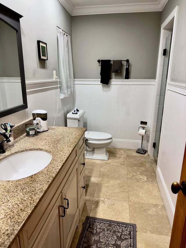 bathroom with vanity, toilet, and crown molding