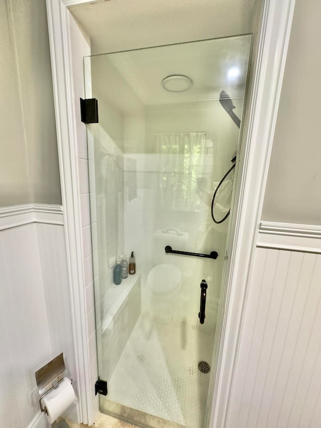 bathroom with a shower with shower door