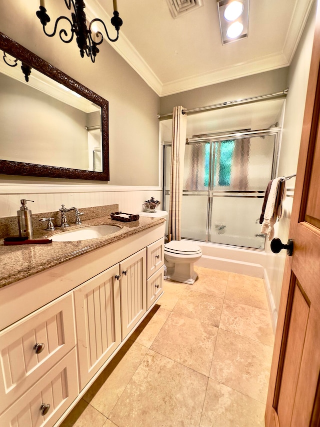 full bathroom with combined bath / shower with glass door, ornamental molding, vanity, tile patterned flooring, and toilet