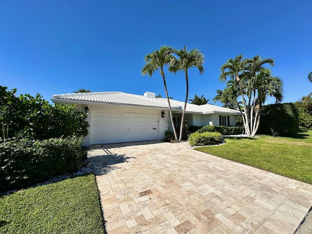 single story home with a front lawn and a garage