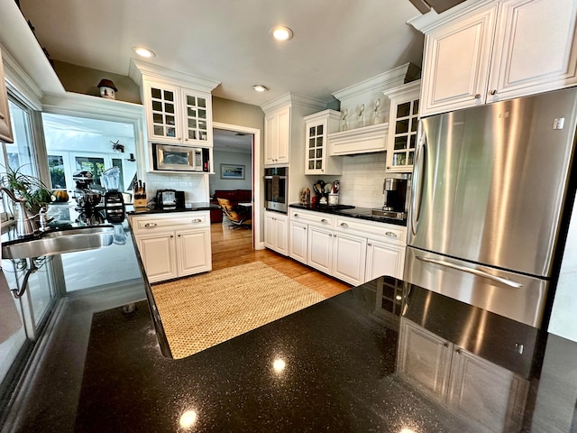 kitchen featuring sink, white cabinetry, stainless steel appliances, and tasteful backsplash