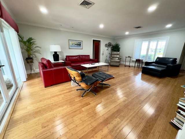 living room with light hardwood / wood-style floors and ornamental molding