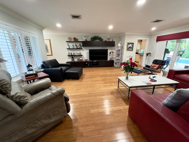 living room with light hardwood / wood-style flooring and ornamental molding