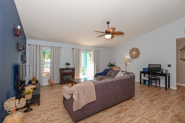 living room with ceiling fan and light hardwood / wood-style floors