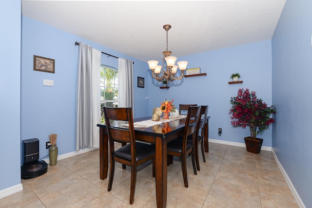 tiled dining room featuring a chandelier