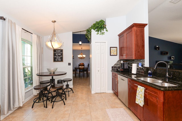 kitchen with hanging light fixtures, sink, stainless steel dishwasher, and vaulted ceiling