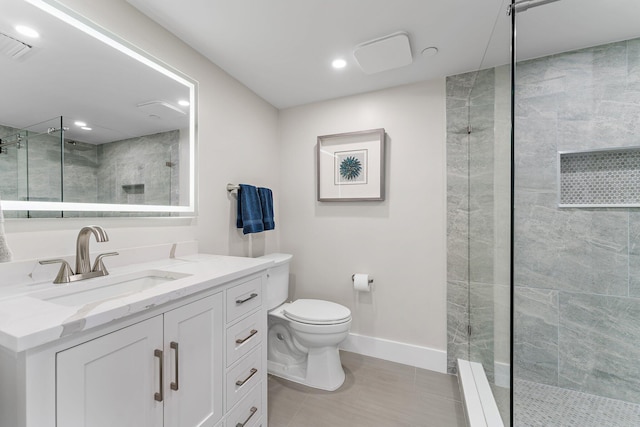 bathroom with tile patterned floors, vanity, toilet, and a tile shower