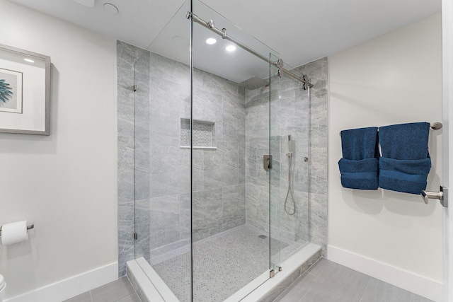 bathroom with tile patterned floors and walk in shower