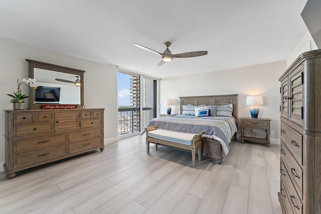 bedroom with ceiling fan, light hardwood / wood-style floors, access to exterior, and expansive windows